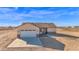Single-Gathering home featuring a two-car garage, desert landscaping, and neutral stucco at 37504 W Elm Ave, Tonopah, AZ 85354