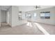 Open living space has neutral paint and tile floors and lots of natural light at 37504 W Elm Ave, Tonopah, AZ 85354