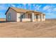 The back exterior features a covered patio, complemented by desert landscaping at 37504 W Elm Ave, Tonopah, AZ 85354