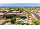 Scenic aerial view highlighting a swimming pool, green yard, and a nearby putting green at 3804 E Daley Ln, Phoenix, AZ 85050