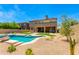Gorgeous pool featuring desert landscaping, a lush lawn, mature trees and a nearby outdoor living space at 3804 E Daley Ln, Phoenix, AZ 85050