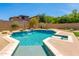 Backyard oasis featuring a custom pool and spa, lush greenery, and peaceful desert landscaping at 3804 E Daley Ln, Phoenix, AZ 85050