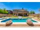 Beautiful backyard pool area with fire bowls, manicured landscaping and lush artificial turf at 3804 E Daley Ln, Phoenix, AZ 85050