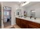 The primary bathroom features dual sinks, white countertops, ceramic tile, and wood cabinets at 3804 E Daley Ln, Phoenix, AZ 85050