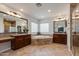 Bright bathroom features a soaking tub, dual vanity sinks, granite countertops, and ceramic tile floors at 3804 E Daley Ln, Phoenix, AZ 85050