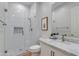 Modern bathroom with glass enclosed shower, marble countertops, and framed artwork at 3804 E Daley Ln, Phoenix, AZ 85050