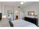 Bright bedroom featuring a comfortable bed, dark furniture, and ensuite bathroom entrance at 3804 E Daley Ln, Phoenix, AZ 85050