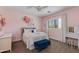 Charming pink bedroom features a plush bed with a gray headboard and a vanity area with a mirror at 3804 E Daley Ln, Phoenix, AZ 85050