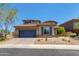 Inviting two-story home with a blue garage door, desert landscaping, and a tile roof at 3804 E Daley Ln, Phoenix, AZ 85050