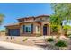 Beautiful two-story home showcasing a blue garage door, tile roof, and desert landscaping at 3804 E Daley Ln, Phoenix, AZ 85050