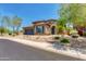 Charming two-story home boasting a blue garage door, desert landscaping, and tile roof at 3804 E Daley Ln, Phoenix, AZ 85050
