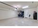 Spacious two car garage with ample storage area, electric vehicle charging, and epoxy floor at 3804 E Daley Ln, Phoenix, AZ 85050