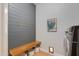 Stylish laundry room with coat hooks, wooden bench, and modern laundry units at 3804 E Daley Ln, Phoenix, AZ 85050