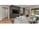 Cozy living room with built-in gray cabinets, a marble fireplace, and sliding doors to the outdoor pool at 3804 E Daley Ln, Phoenix, AZ 85050