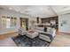 Open-concept living room showcases a spacious sectional sofa, modern ceiling fan, and backyard access at 3804 E Daley Ln, Phoenix, AZ 85050