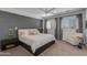 Serene main bedroom featuring gray accent wall, plantation shutters, and designer lighting at 3804 E Daley Ln, Phoenix, AZ 85050