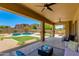 Covered patio overlooking the lush yard and pool, creating a perfect outdoor living experience at 3804 E Daley Ln, Phoenix, AZ 85050