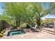 Backyard with spa, seating, mature trees and native desert landscape at 41916 N 101St N Pl, Scottsdale, AZ 85262