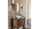 Stylish powder room featuring a vessel sink on a wooden vanity and decorative mirror at 41916 N 101St N Pl, Scottsdale, AZ 85262