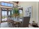Open dining room with a large wood table, seating for eight, and scenic views from the sliding glass doors at 41916 N 101St N Pl, Scottsdale, AZ 85262