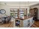 Farmhouse kitchen featuring a large island, custom cabinetry, and opens to the breakfast nook at 41916 N 101St N Pl, Scottsdale, AZ 85262