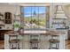 Farmhouse kitchen featuring a large island, custom cabinetry, and a scenic desert view at 41916 N 101St N Pl, Scottsdale, AZ 85262