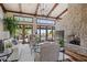Bright living room featuring high, beamed ceilings, wood floors, a stone fireplace, and large windows at 41916 N 101St N Pl, Scottsdale, AZ 85262