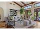 Bright living room featuring high, beamed ceilings, wood floors, stylish furnishings and patio access at 41916 N 101St N Pl, Scottsdale, AZ 85262