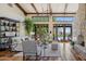 Bright living room featuring high, beamed ceilings, wood floors, a stone fireplace, and patio access at 41916 N 101St N Pl, Scottsdale, AZ 85262