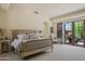 Bright main bedroom with a king bed, seating area, and sliding doors leading to the outdoor space at 41916 N 101St N Pl, Scottsdale, AZ 85262