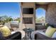 Outdoor living area with fireplace, grill, seating and views of the desert landscape at 41916 N 101St N Pl, Scottsdale, AZ 85262