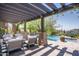 Beautifully designed outdoor space with a pool, lounge chairs, and pergola at 41916 N 101St N Pl, Scottsdale, AZ 85262
