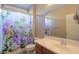 Charming bathroom with butterfly-themed shower curtain, vanity, toilet, and large mirror at 42360 W Abbey Rd, Maricopa, AZ 85138