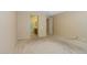 Large bedroom with carpet, light-colored walls, and an en-suite bath and walk-in closet at 42360 W Abbey Rd, Maricopa, AZ 85138