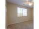 A serene bedroom is spacious with plush carpeting, ceiling fan, and a large window at 42360 W Abbey Rd, Maricopa, AZ 85138