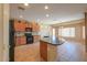 Gourmet kitchen boasting granite countertops, a black appliance package, and warm cabinetry at 42360 W Abbey Rd, Maricopa, AZ 85138