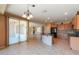 Spacious kitchen with island and an adjacent living area, enhancing a harmonious living experience at 42360 W Abbey Rd, Maricopa, AZ 85138