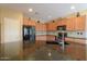 Close-up of the kitchen island with granite countertop, sink, and black appliances, creating a modern cooking space at 42360 W Abbey Rd, Maricopa, AZ 85138
