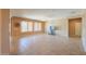 Large living room featuring neutral walls, tile flooring, ceiling fan, and ample natural light through expansive windows at 42360 W Abbey Rd, Maricopa, AZ 85138