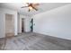 This spacious carpeted bedroom has a ceiling fan plus closet and bathroom access at 43938 W Colby Dr, Maricopa, AZ 85138