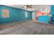 Neutral carpet and bright wall colors enhance this open living area with lots of natural light at 43938 W Colby Dr, Maricopa, AZ 85138
