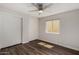 This bedroom features wood floors, a ceiling fan, and a window at 4502 E Carol Ave # 4, Mesa, AZ 85206