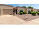 Charming single-story home boasts a desert landscape, attached garage and a well-manicured lawn at 4502 E Carol Ave # 4, Mesa, AZ 85206
