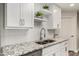 Updated kitchen boasts granite countertops, stainless steel faucet, and crisp white cabinets at 4502 E Carol Ave # 4, Mesa, AZ 85206