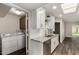 Modern kitchen with granite counters, stainless appliances, and laundry area at 4502 E Carol Ave # 4, Mesa, AZ 85206