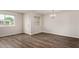 Bright living room features hardwood floors, abundant natural light and a stylish chandelier at 4502 E Carol Ave # 4, Mesa, AZ 85206