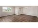 Bright living room with hardwood floors, large window and simple chandelier fixture at 4502 E Carol Ave # 4, Mesa, AZ 85206