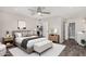 Serene primary bedroom featuring a ceiling fan, minimalist decor, and an ensuite bathroom at 4502 E Carol Ave # 4, Mesa, AZ 85206