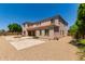 Expansive backyard featuring gravel ground cover, stone pavers, and a cozy outdoor fire pit, perfect for entertaining at 4724 S Anitole Way, Mesa, AZ 85212