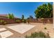 Expansive backyard featuring desert landscaping, trees, and a brick privacy wall at 4724 S Anitole Way, Mesa, AZ 85212